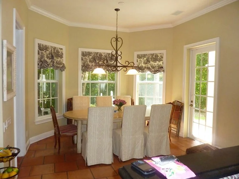 Breakfast nook with farmhouse table and French country elements