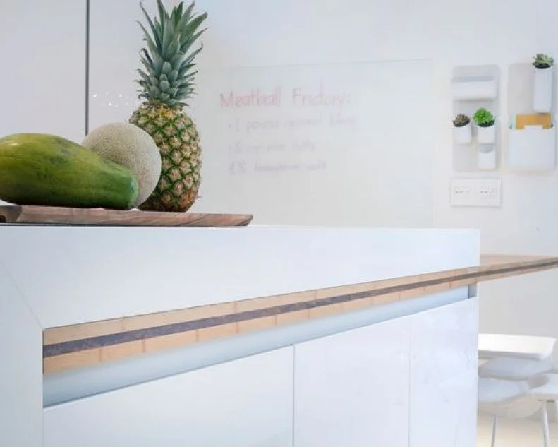 Cantilevered kitchen island and functional whiteboard