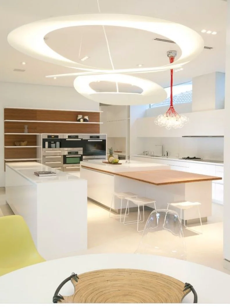 Large, suspended sculpture hangs in a minimalist kitchen