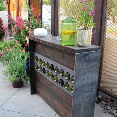 Flowering Plants Grace a Rustic Outdoor Sideboard Wine Rack