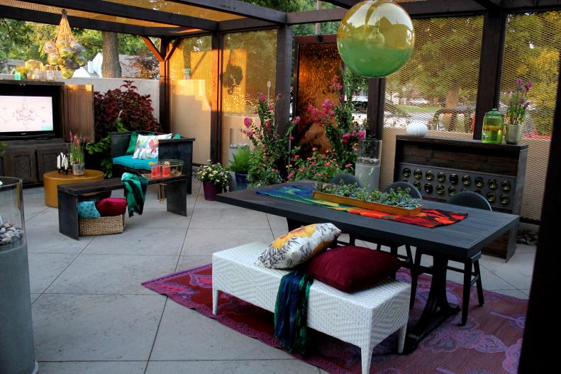 A patio courtyard with ample seating and colorful textiles