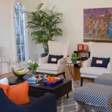Eclectic White Living Room With Navy and Orange Accents