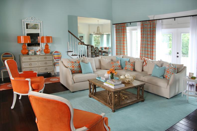 Light Blue Coastal Living Room With Orange Armchairs & Beige Sectional
