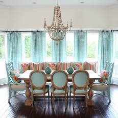 Coastal Dining Room With Aqua Decor and Ornate Chandelier