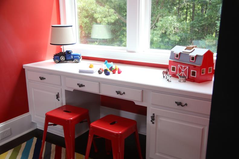 Traditional White Desk and Contemporary Red Stools in Red Playroom
