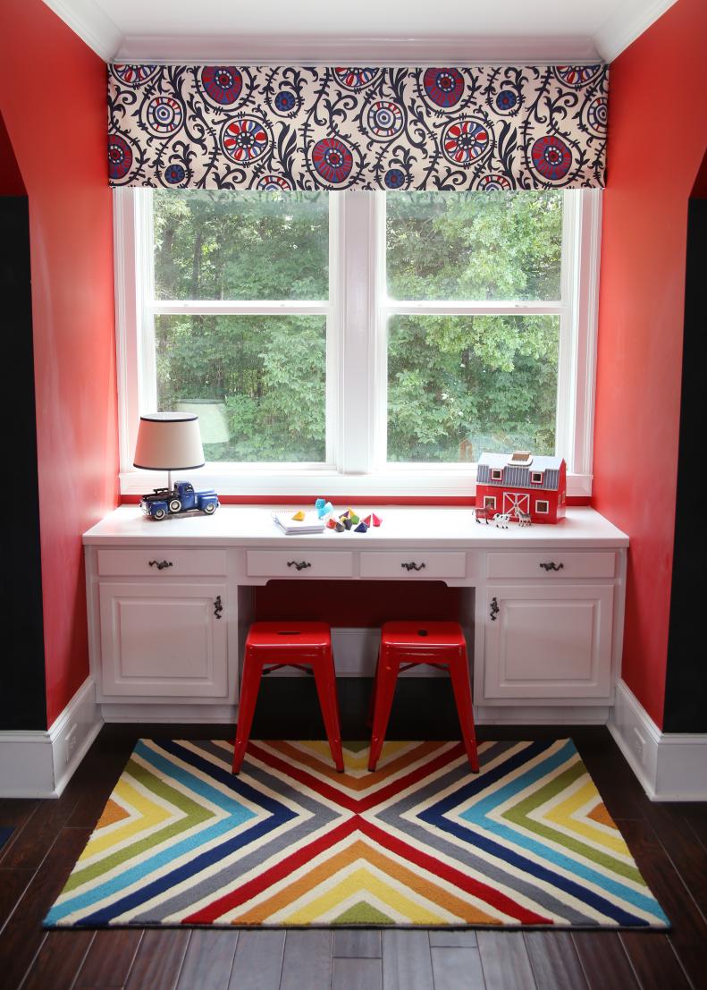 Eclectic Red Playroom With White Desk, Red Stools and Colorful Rug
