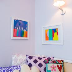 Colorful Artwork and Patterned Pillows in Girl's Bedroom