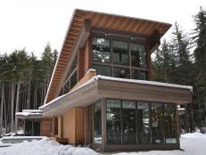 Modern Brown Home With Large Windows in Snowy Wilderness