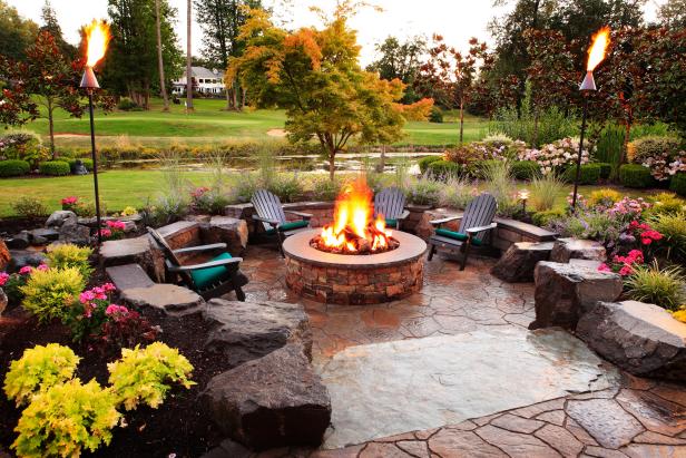 Transitional Patio With Fire Pit and Black Adirondack Chairs