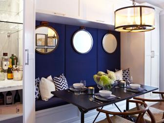 Small White Dining Area With Navy Upholstered Banquette & Black Table