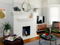 Light Gray Living Room With White Fireplace and Black Coffee Table