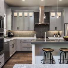 Light Gray Cabinetry Complements White Island in Sleek, Custom Kitchen