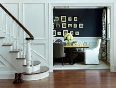 Foyer With White Wall Paneling and View of Dining Room