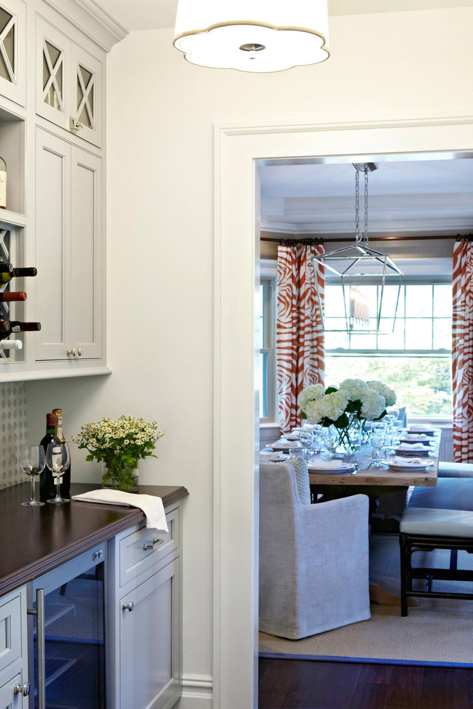 neutral transitional butler's pantry with view of dining