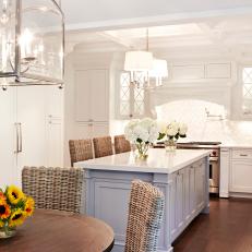 Open Plan Kitchen With White Cabinets and Gray Island