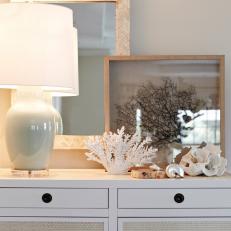 White Dresser With Acrylic Lamp and Coastal Accessories