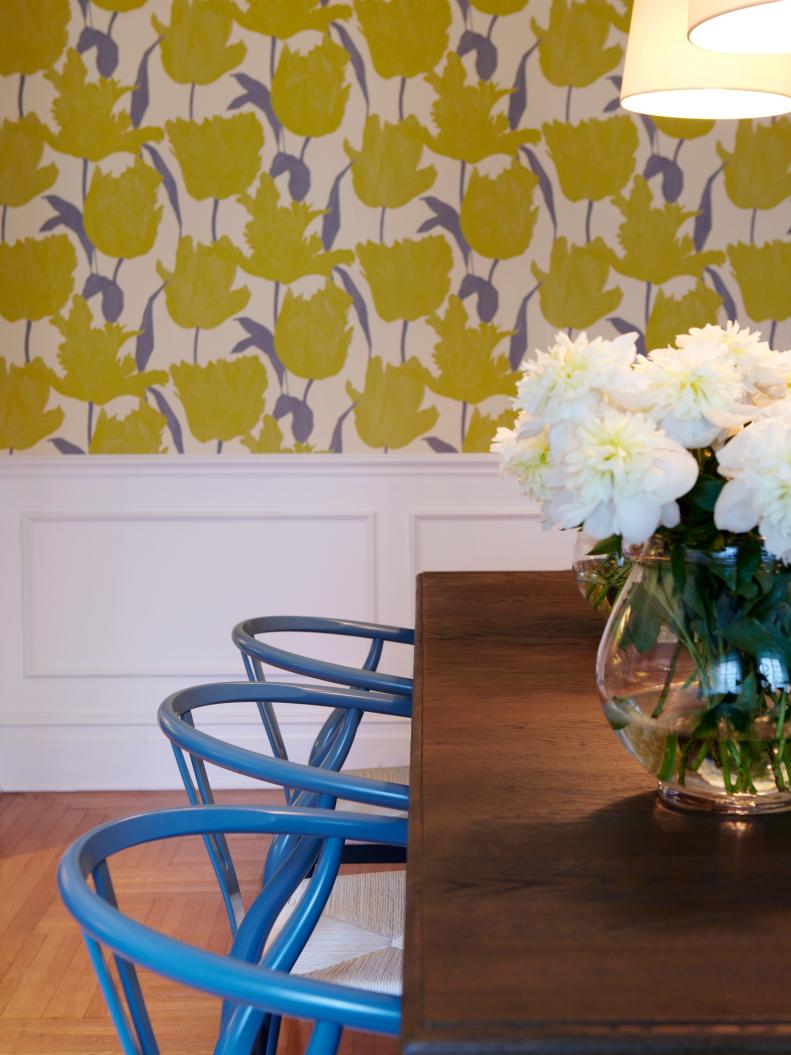 Dining Room With Yellow Patterned Wallpaper and Blue Chairs