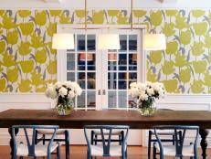 Dining Area With Yellow Floral Wall, White Chandelier and Wainscoting