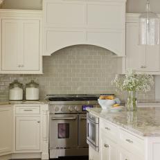 Kitchen With White Cabinets and Neutral Tile Backsplash