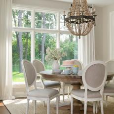 Breakfast Room With Round Wood Table and Chandelier