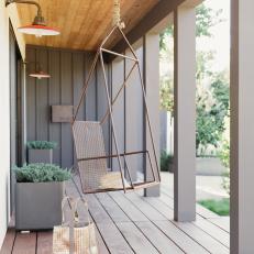 Gray Porch Boasts Contemporary Metal Hanging Chair
