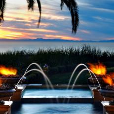 Tropical View From Pool With Fountains and Torches