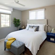 Neutral Transitional Bedroom With Bold Blue Nightstand