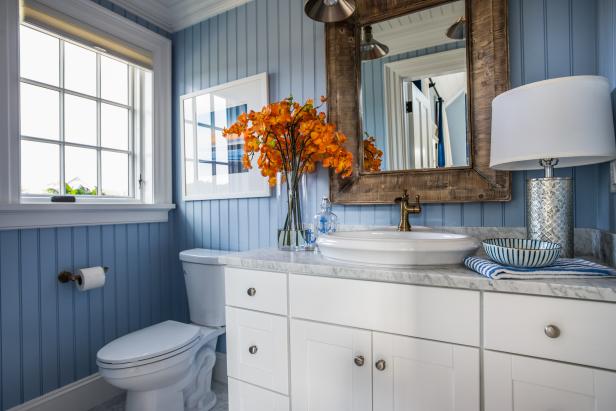Blue toilet and louvre room divider in seventies bathroom with