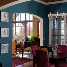 Blue Open Plan Dining Area With Chandelier
