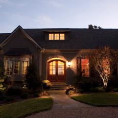 Stone Home Exterior and Flagstone Walkway at Night