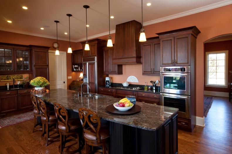 Orange Traditional Kitchen Wood Cabinetry and Pendant Lights