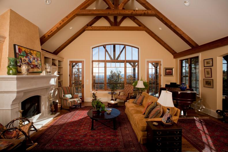 Neutral Living Room With Traditional Red Rug, Mustard Sofa, Beams