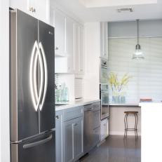 White and Gray Midcentury Modern Kitchen With Stainless Steel Refrigerator