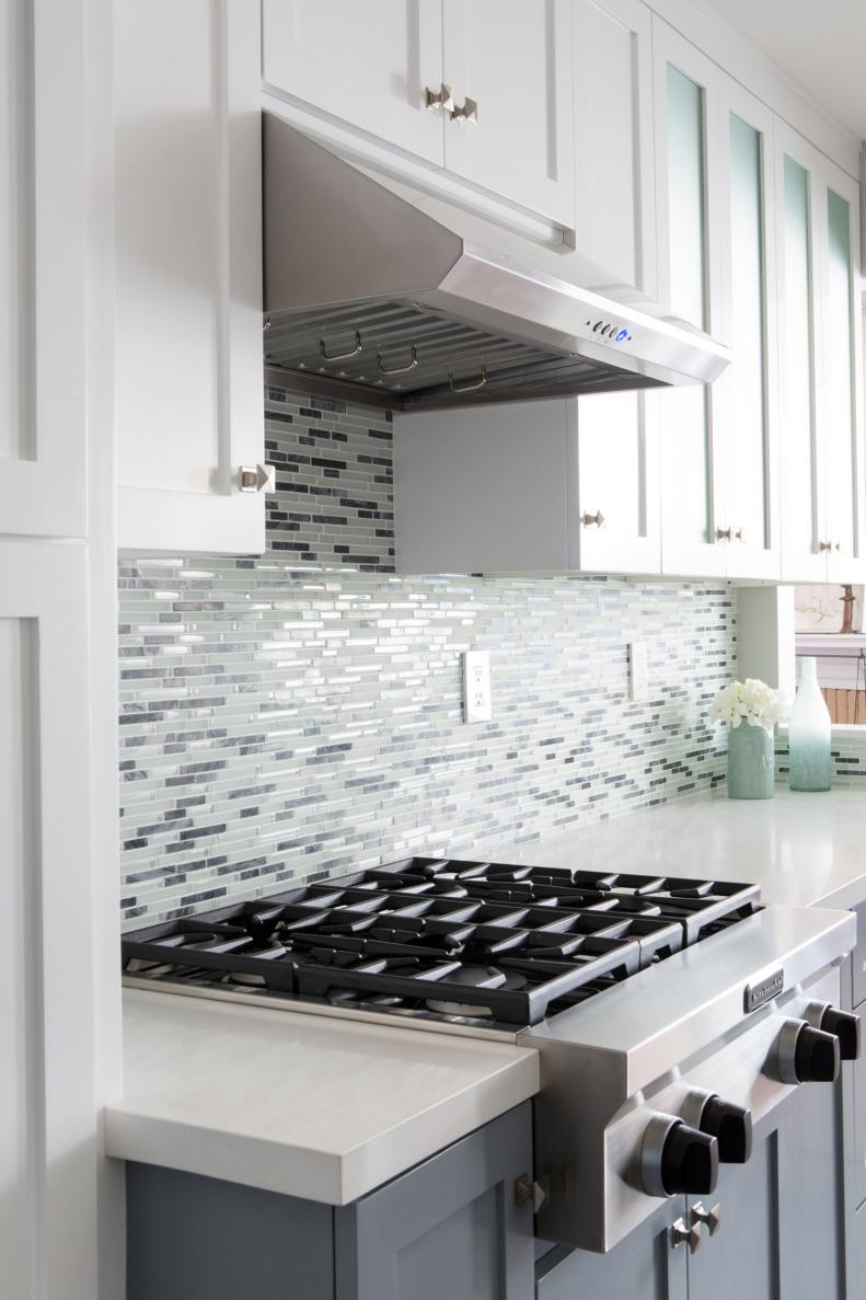 White Midcentury Modern Kitchen With Stove and Glass Tile Backsplash
