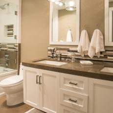 Elegant Bathroom With Brown and Neutral Tiled Backsplash