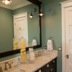 Teal Bathroom With Marble-Topped Dark Wood Vanity