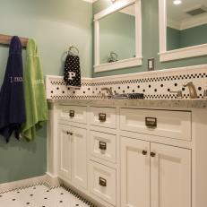 Teal Blue Kid's Bathroom With White Vanity and Tile Floor
