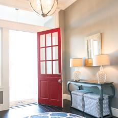 Entryway With Red Front Door and Moroccan Print Rug