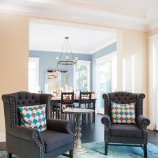 Sitting Room With Tufted Brown Chairs and Pedestal Table