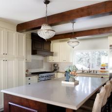 Elegant Eat-In Kitchen With Exposed Beams and Island Seating