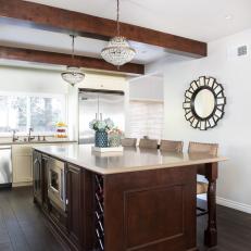 Elegant Kitchen With Exposed Beams, Spacious Island and Chandeliers