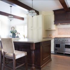 Classy Eat-In Kitchen With Wood Range Hood and Spacious Island