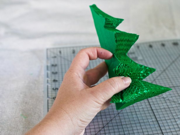 Fan out Christmas tree-shaped honeycomb paper to create a holiday centerpiece.