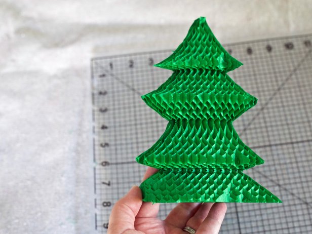 Fan out Christmas tree-shaped honeycomb paper to create a holiday centerpiece.