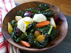 Add vegetables and two poached eggs to kale to make a delicious brunch salad for holiday guests.