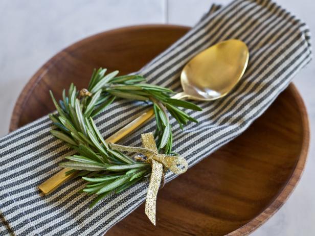 Place wreath-shaped rosemary on each guest's place setting for an easy holiday tablescape idea.