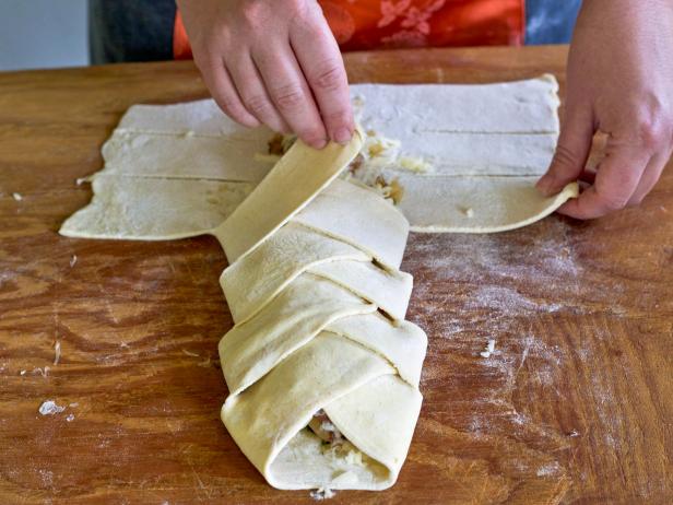 Braid dough strips to enclose the cheese and herb wreath pastry filling.