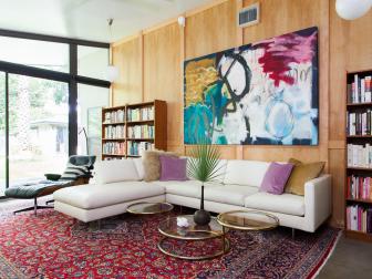 Transitional Family Room With Red Area Rug, White Sectional & Mod Art