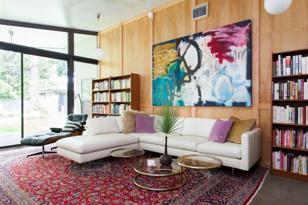 Transitional Family Room With Red Area Rug, White Sectional & Mod Art