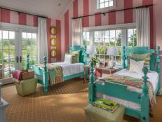 Part whimsical retreat, part cozy place for bedtime stories, this colorful escape features soaring ceilings and playful striped walls.